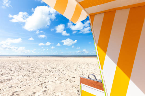 Empty hooded beach chair at the the coastline of the island Langeoog - Germany. Copy space