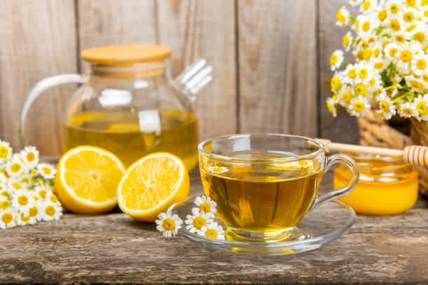 istock Chamomile tea in a  cup on a  texture background. Natural hour with chamomile flowers. Herbal tea. Immunity tea.Natural healer concept. Healthy detox drink.Close up. Place for text. 1688464642