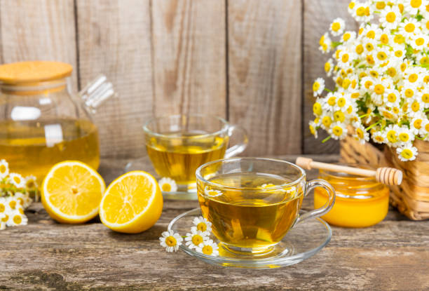 istock Chamomile tea in a  cup on a  texture background. Natural hour with chamomile flowers. Herbal tea. Immunity tea.Natural healer concept. Healthy detox drink.Close up. Place for text. 1688489243