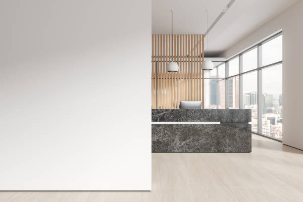 istock Cozy office reception interior desk with pc computer, window and mockup wall 1688491273