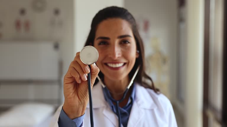 Latina female cardiologist posing at workplace with stethoscope