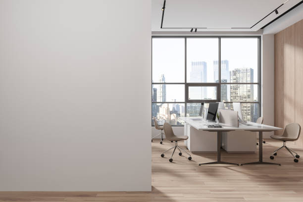istock White and wooden open space office interior with blank wall 1688506667