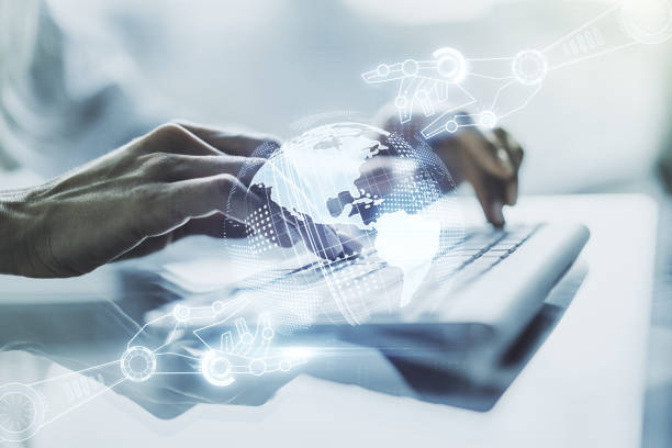Double exposure of robotics technology with world map hologram and hands typing on laptop on background. Research and development software concept stock photo