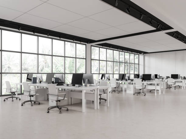 istock Stylish office interior with pc computer in row, desk near panoramic window 1688508832