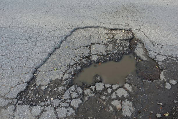 istock Pothole on asphalt road filled with water 1688511727