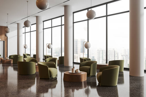 istock Stylish hotel interior lobby with soft armchairs and coffee table, window 1688517133