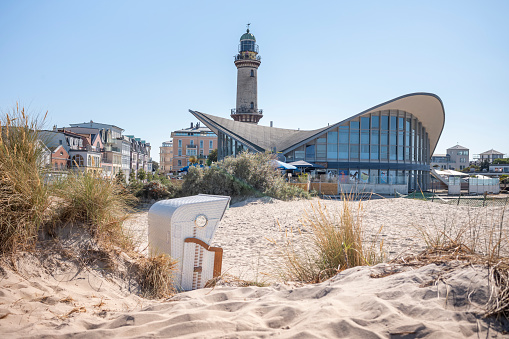 Rostock Warnemünde, Mecklenburg-Western Pomerania, Germany - September 9, 2023: View of the lighthouse and teapot on the beach with dunes on the day in summer.