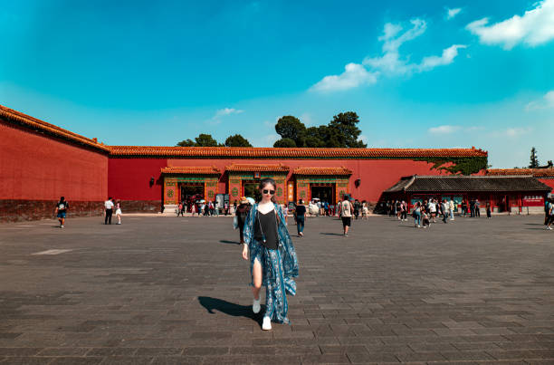 A beautiful woman in traditional costume is taking portrait photos at the Meridian Gate of the Forbidden City in Beijing Forbidden City, ancient Chinese royal palace, world famous historical building in Beijing, China forbidden city beijing architecture chinese ethnicity stock pictures, royalty-free photos & images