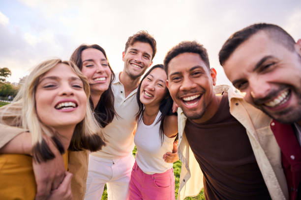 istock Multiracial people happy group smiling at camera for photo outdoors on sunny day. Diverse laughing. 1688525273