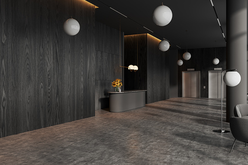 Corner of stylish hotel hall with gray and dark wooden walls, concrete floor, cozy gray reception counter with flowers, two elevators and armchairs. 3d rendering