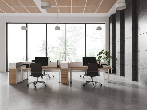istock Stylish coworking interior with pc computer and armchairs in row, window 1688534496