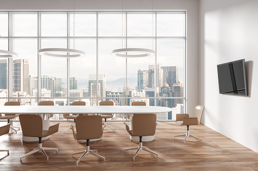 Cozy meeting room interior with chairs and board on hardwood floor. Conference space with tv monitor and panoramic window on Kuala Lumpur skyscrapers. 3D rendering