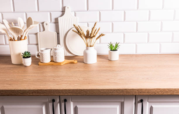 istock White ceramic utensils and kitchen utensils on a wooden countertop in an eco-friendly kitchen with green indoor plants. Cozy house 1688538825