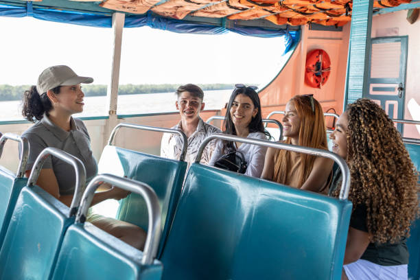 istock Tour guide directing tourists on a passenger boat 1688560080