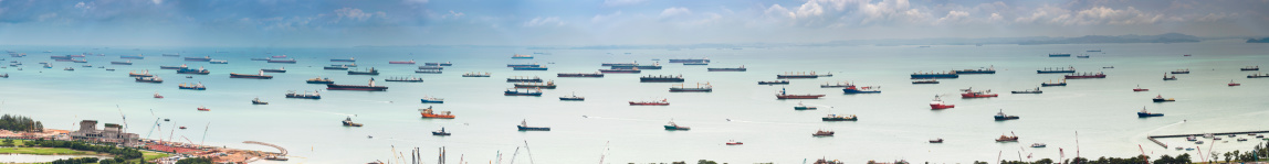 Fleets of container ships, cargo carriers, oil tankers and tug boats crowding the turquoise waters of the Straits of Singapore, one of the busiest shipping lanes and harbours in the world. ProPhoto RGB profile for maximum color fidelity and gamut.