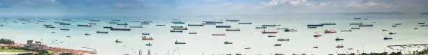 Photo of Container ships cargo freighter shipping moored in ocean harbour panorama