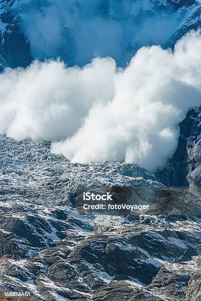 Avalanche Snowfall Cascading Down Mountain Onto Glacier Stock Photo - Download Image Now