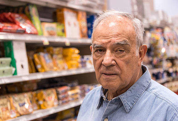 istock Hispanic senior man buying fruit 168856469