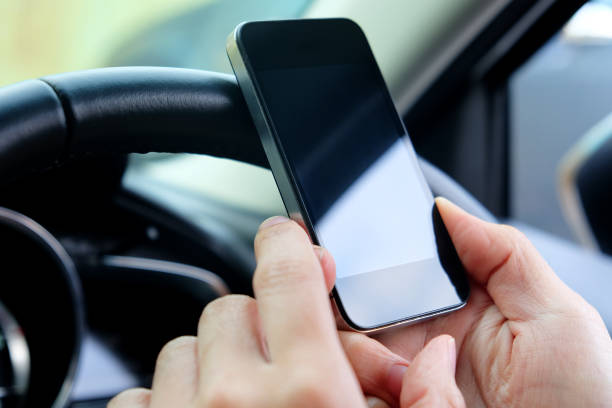 istock image of using a mobile phone inside of a car 1688573988