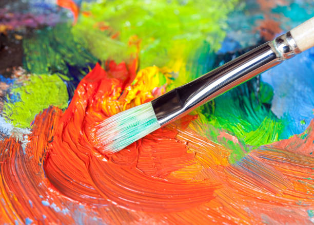 istock Paintbrush with oil paint on a classical palette 168857661