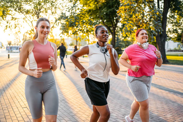 istock Three Young Female Friends Jogging In The Park 1688576775