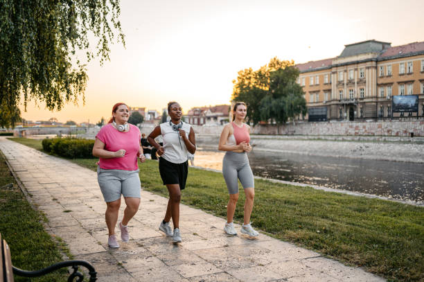 istock Three Young Female Friends Jogging On The Quayside 1688577294