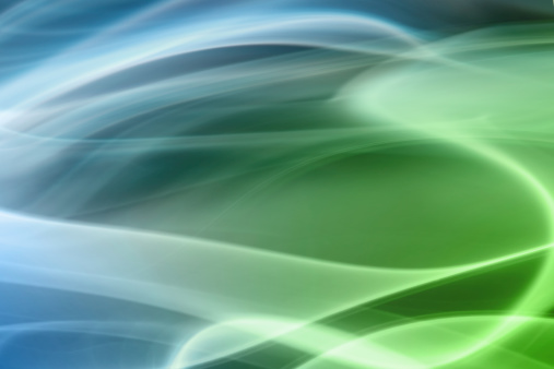 Green glowing energy bright waves from small particles and lines abstract background.