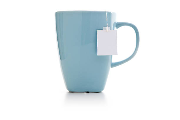 blaue tasse mit tee-tasche - tea cup stock-fotos und bilder