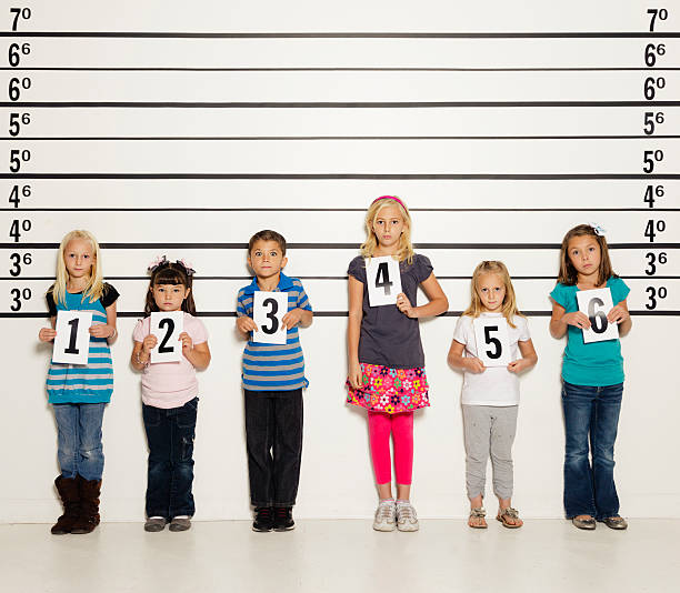 Police Line-Up of Six Children A police station line-up of six unhappy children. child arrest stock pictures, royalty-free photos & images