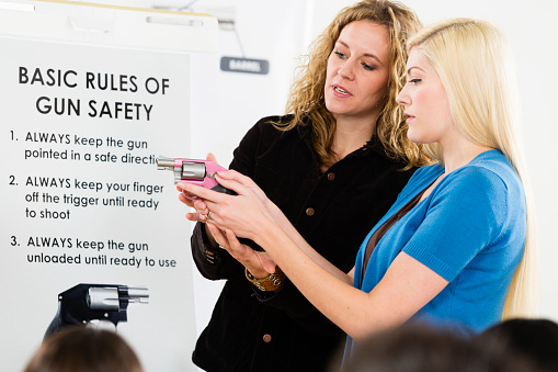 An instructor teaching a gun safety class to a group of students.