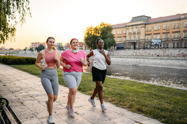 istock Three Young Female Friends Jogging On The Quayside 1688579970
