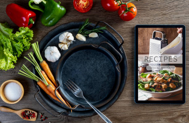 istock Food recipes tablet computer on rustic wooden table 1688579982