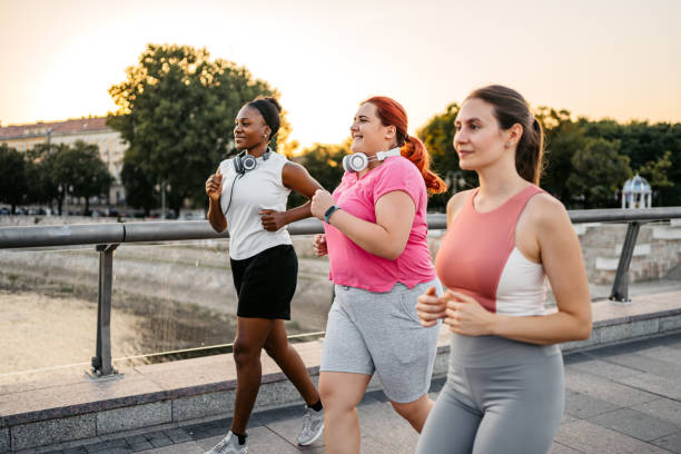 istock Three Young Female Friends Jogging On The Bridge 1688591363