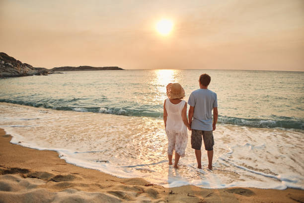 istock Senior couple enjoying walking along the beach 1688591893
