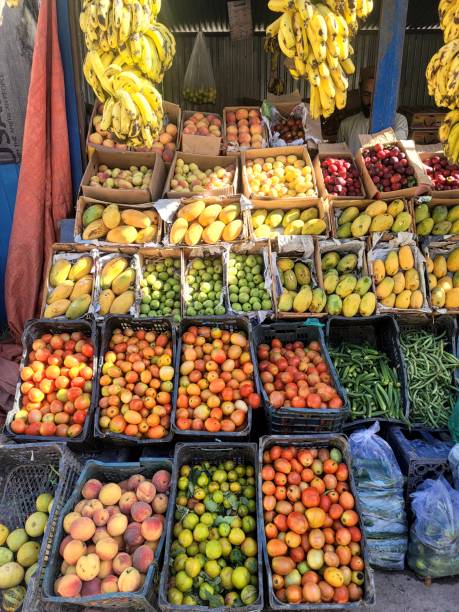 fresh fruit piled high on shelves on a market stall in pakistan balkot - 4605 imagens e fotografias de stock