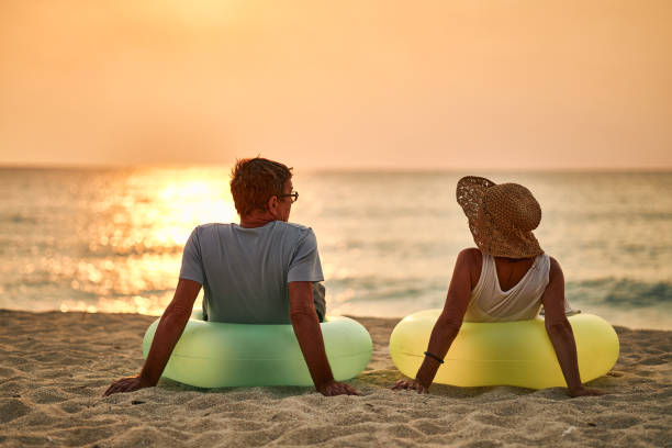 istock Senior couple enjoying sunrise on the beach 1688606862