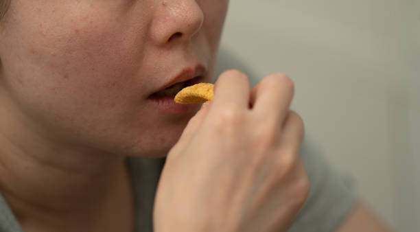 istock close up of mouth eating snack 1688608037