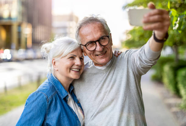 istock Senior couple using smartphone in the city 1688639432