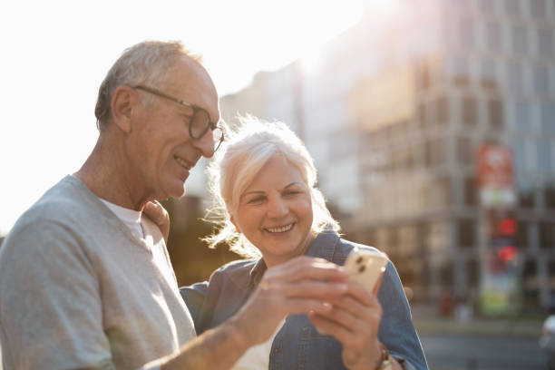 istock Senior couple using smartphone in the city 1688639442
