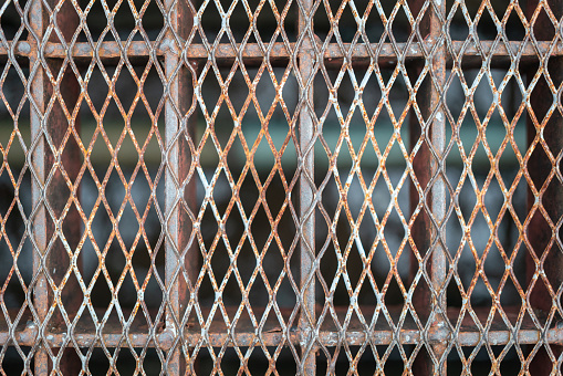 Close-up at rustic steel grate that using for cover the sewer drain way. Object, background texture photo.