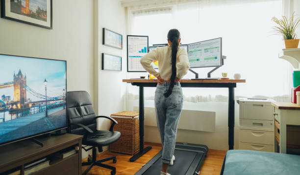 istock Woman with back pain working at standing desk home office 1688654582