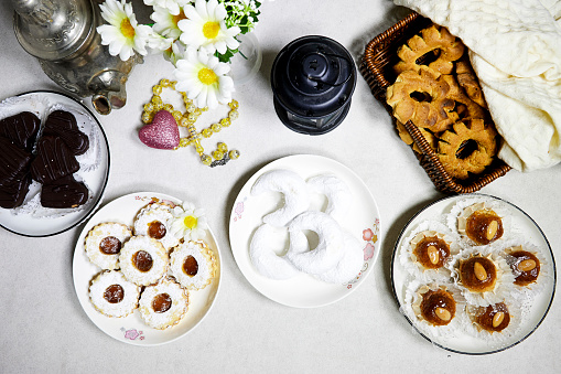 eid holiday table : Oriental Algerian sweet cookies named dziriettes and kaak tlemcen is dry cookies, heart shaped chocolate with jam apricot cookies