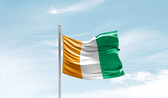 Ivory Coast national flag waving in the sky.