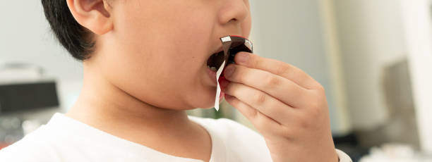 istock kid eating chocolate bar in room ,close up 1688674401