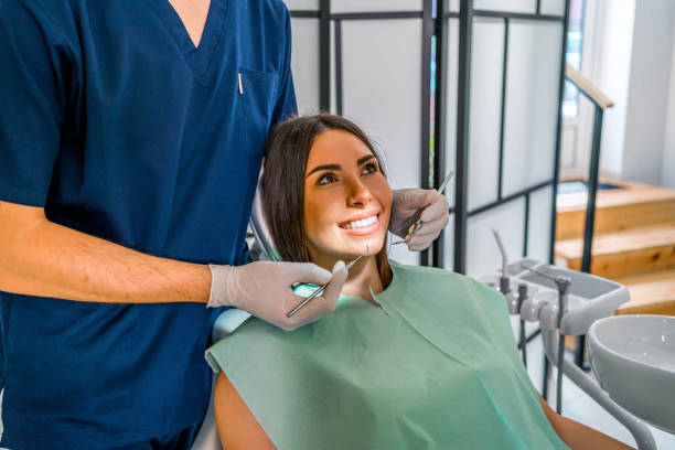 istock Woman examining her teeth at the dentist 1688677657