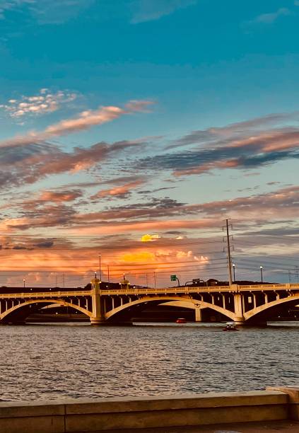 istock Bridge over a summer lake with brilliant sunset 1688678851