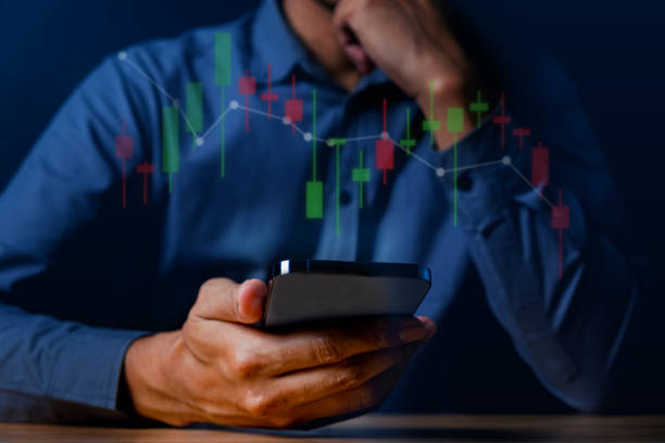 istock Economic crisis, Businessman using mobile smartphone analyzing sales data and economic graph chart that is falling. 1688713437