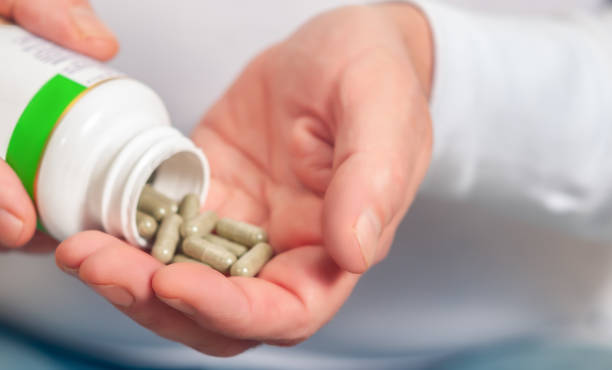 istock Hand Holding Medicine Pill Close-Up 1688731256