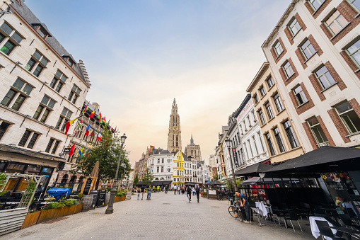 Antwerp, Belgium - June 29, 2023: Antwerp the old historical and touristic city of Belgium, general view of the famous Cathedral of our Lady and historical houses from the street in summer.