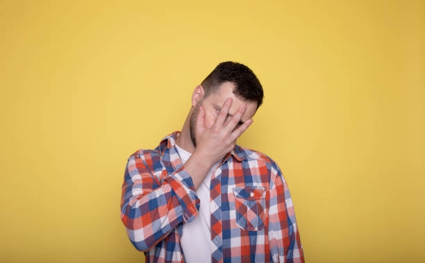 istock Man face palm and mistake in studio with thinking, regret and anxiety for fail on yellow. 1688739614